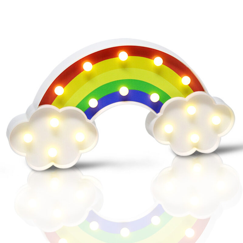A white LED Rainbow Party Light with colorful illuminated arcs (red, orange, yellow, green, blue, purple) and two illuminated white clouds, resting on a reflective surface.