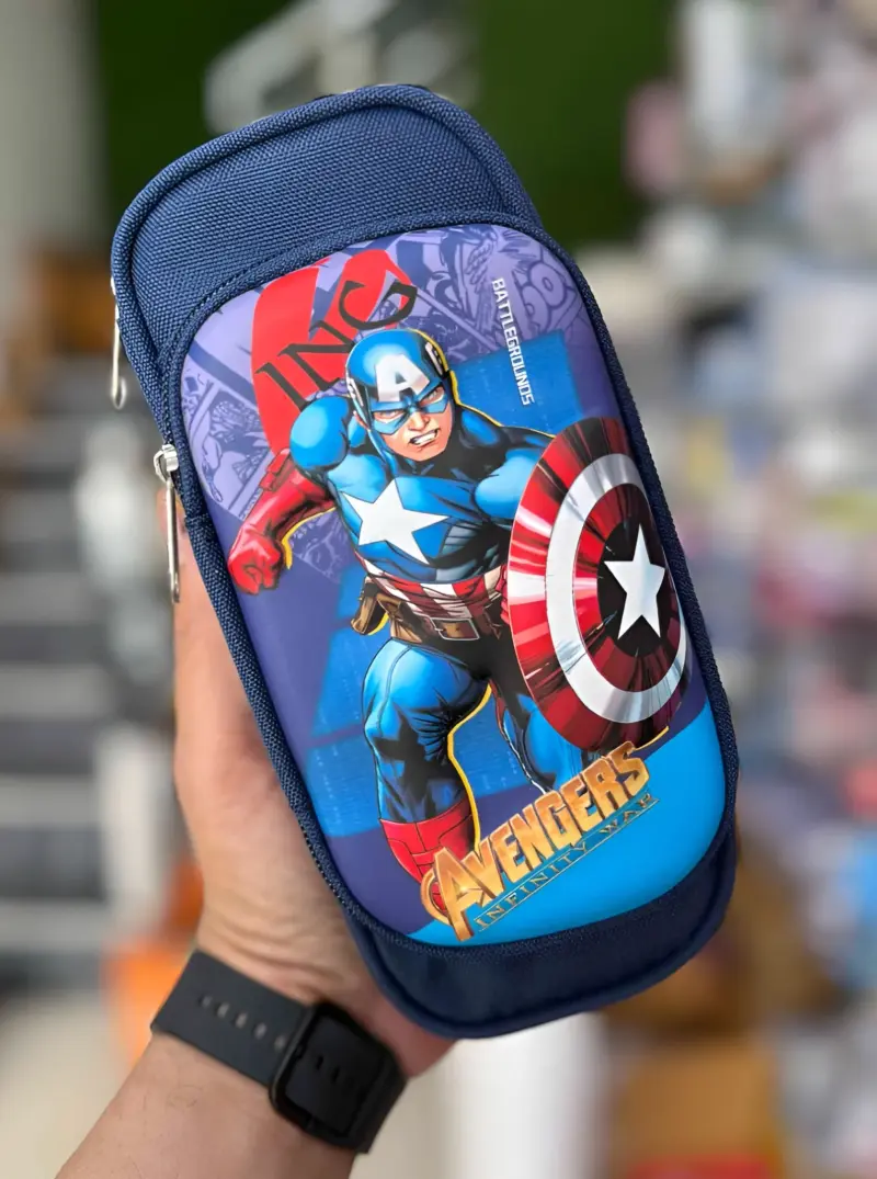 A hand holding a blue Avengers Pencil Pouch featuring a prominent graphic of Captain America with his shield, highlighting the detailed character design.