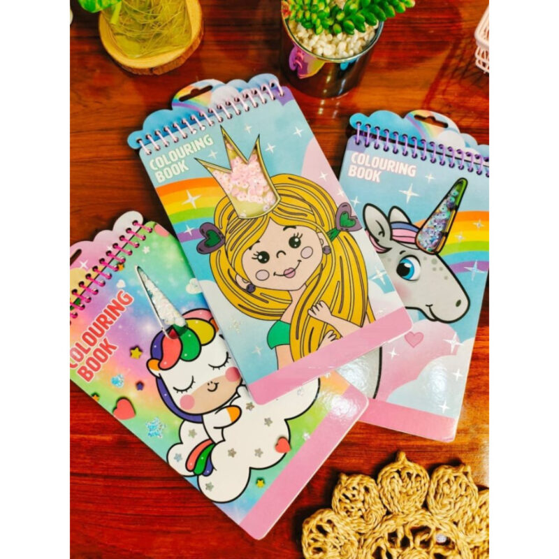 Three spiral-bound Coloring Sticker Books featuring covers with a princess, a happy unicorn, and a sleeping unicorn, displayed on a wooden table.
