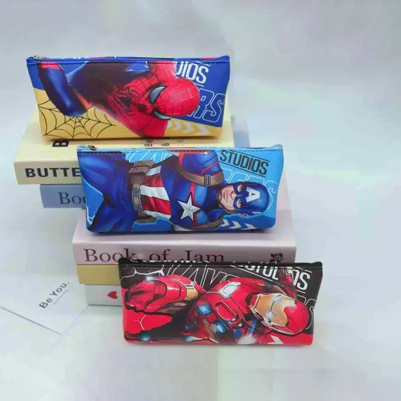 Three Avengers Small Pouches featuring Spider-Man, Captain America, and Iron Man designs, stacked on books on a light surface.