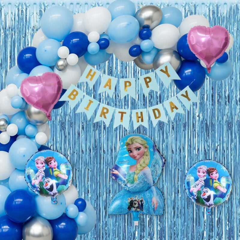 A fully decorated party setup featuring the Ultimate Frozen Theme DIY Pack, with a blue foil curtain backdrop, a large balloon arch in blues, white, and silver, "HAPPY BIRTHDAY" banner, and Frozen character foil balloons (Elsa, Anna, Olaf).