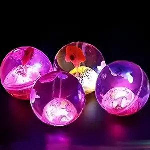 A group of glowing, translucent LED Bounce Balls in purple and pink hues, showing internal light and designs, against a dark background.