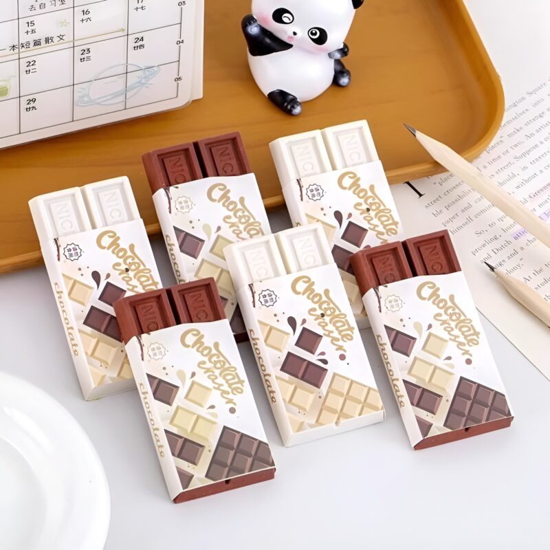 A neat arrangement of several Chocolate Slab Erasers, some in their wrappers and some partially exposed, alongside a panda figurine and a pencil, highlighting their novelty appeal.