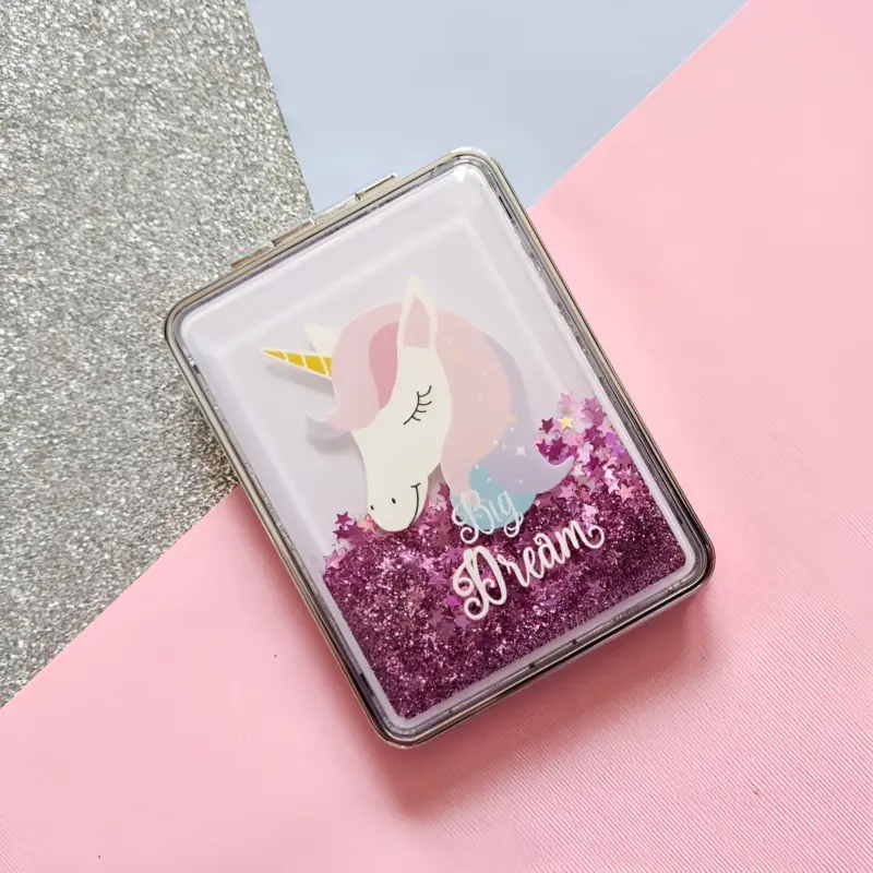 A glittery Unicorn Mirror Keychain with a round shape featuring a unicorn face, horn, and rainbow mane, showing the mirror inside when opened.