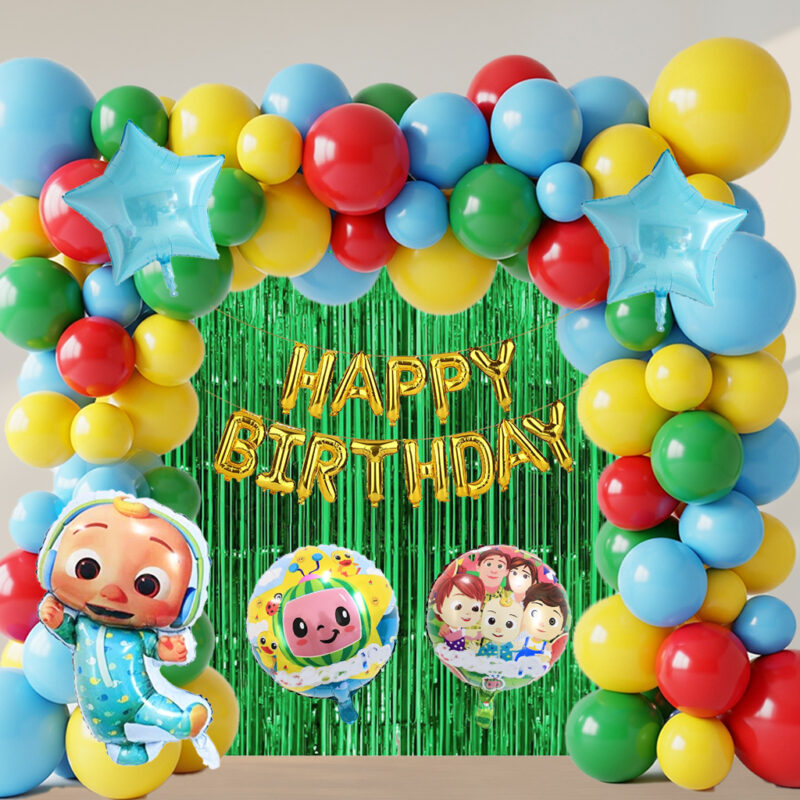 An Ultimate Cocomelon Essential Kit setup with a large colorful balloon arch in blue, yellow, red, and green, a green fringe foil curtain, gold "HAPPY BIRTHDAY" foil balloons, and Cocomelon character foil balloons, creating a vibrant party backdrop.
